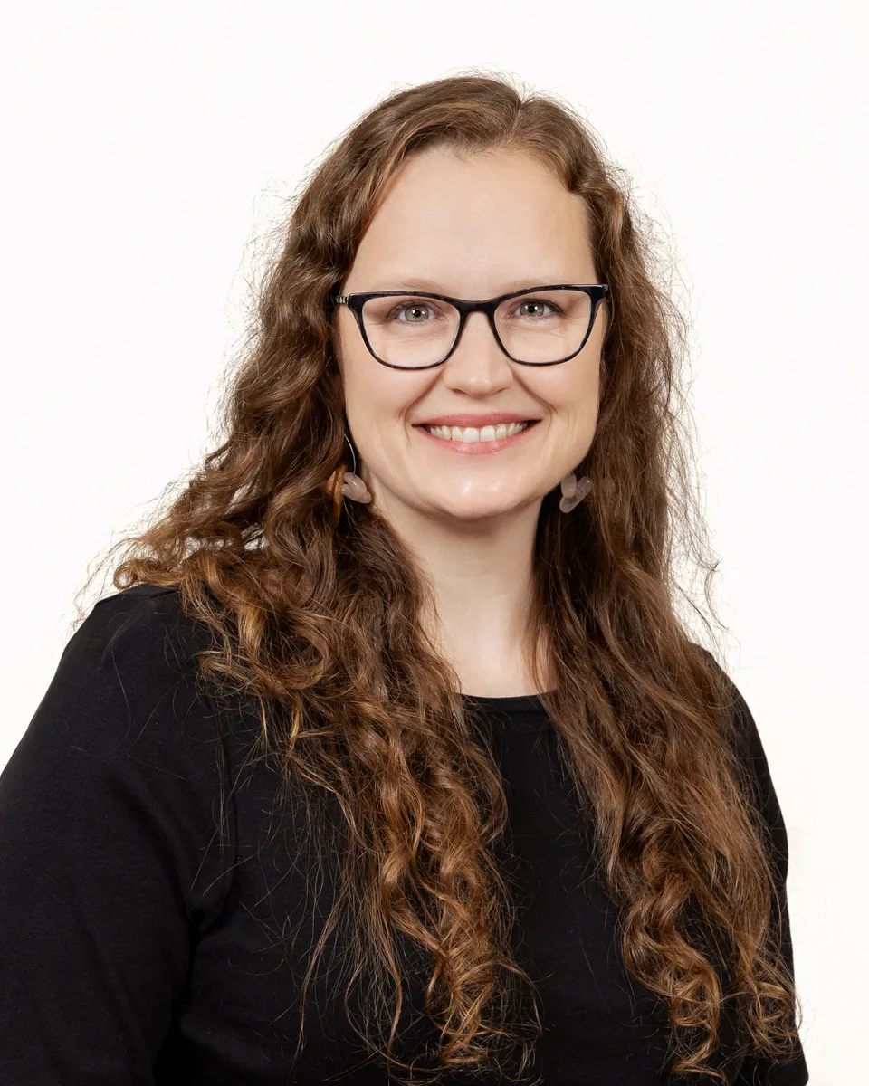 Professional headshot with friendly expression