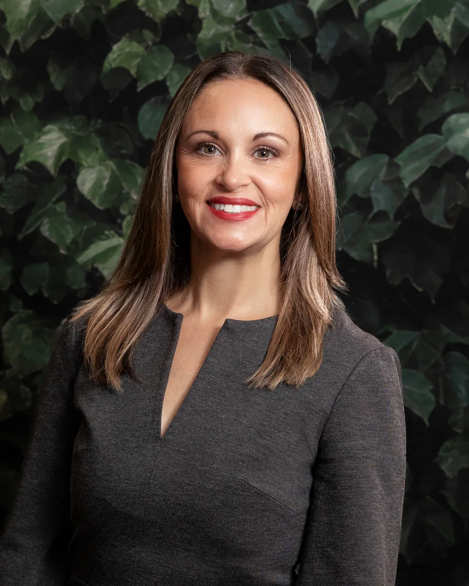 Professional headshot with modern background
