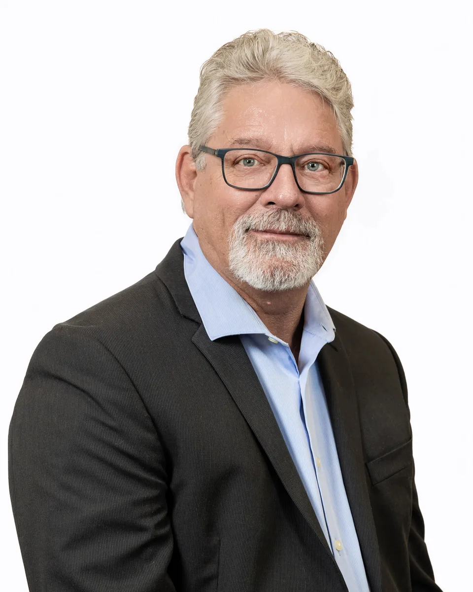 Executive headshot with subtle background