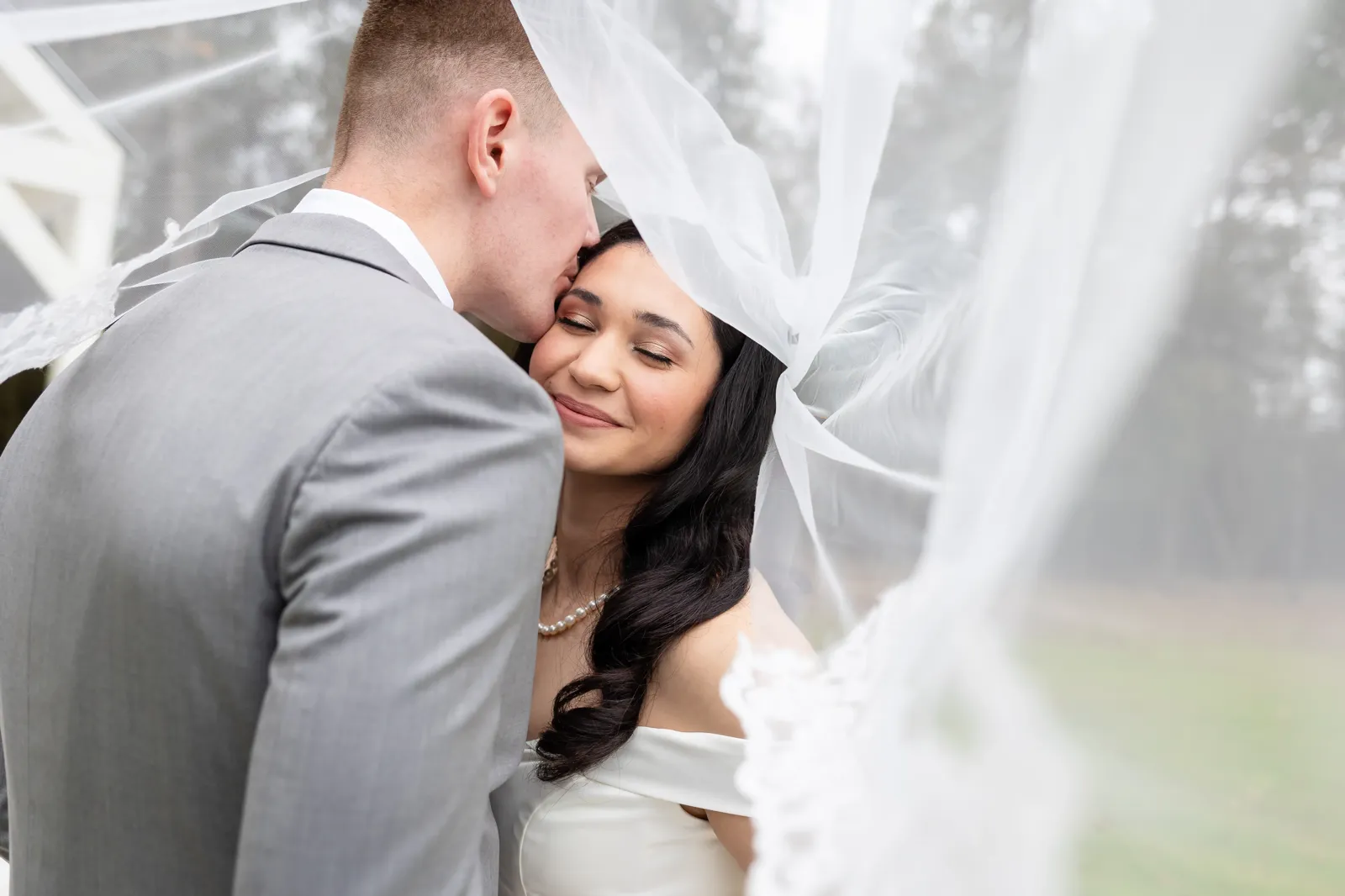 Intimate veil portrait kiss