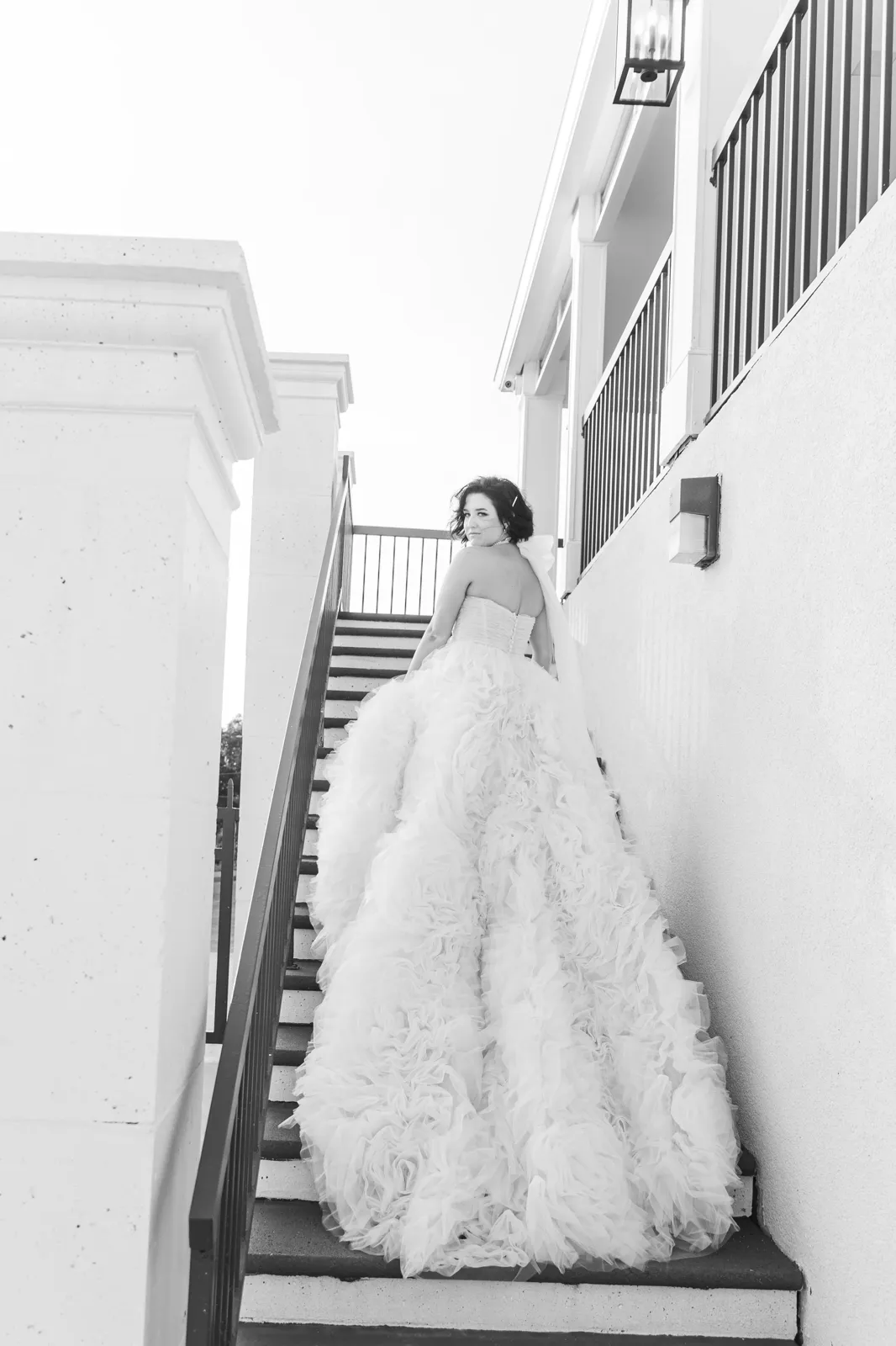 Bride on staircase with dramatic textured gown