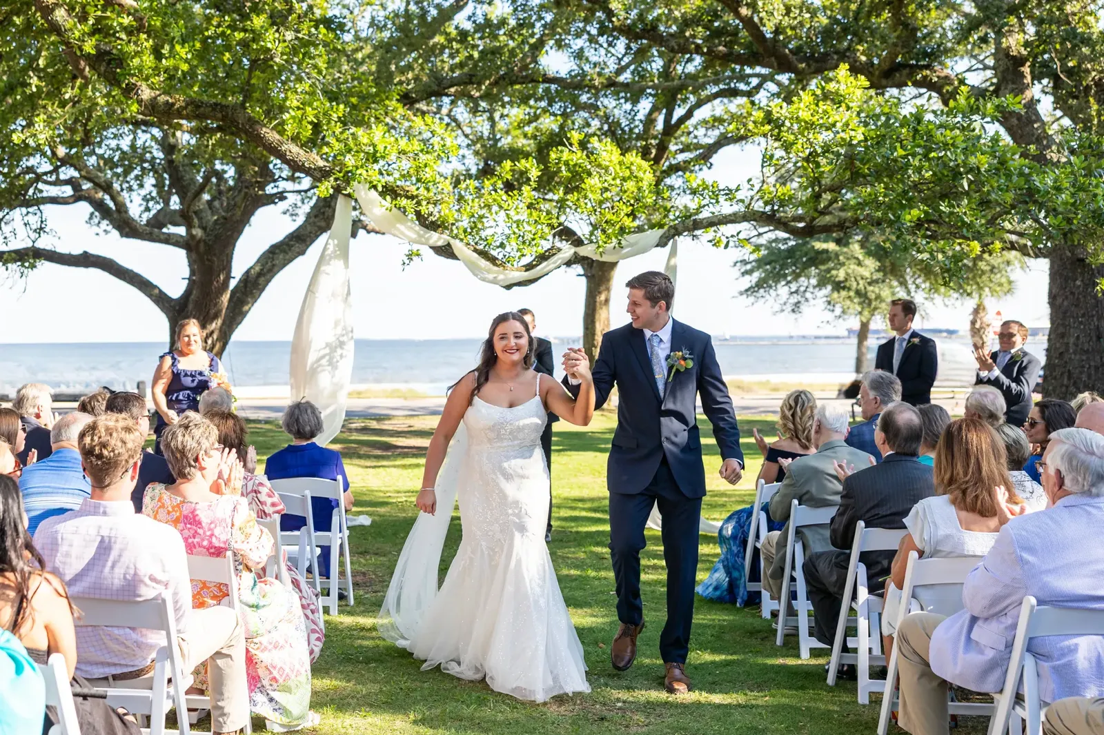 Joyful recessional with waterfront backdrop