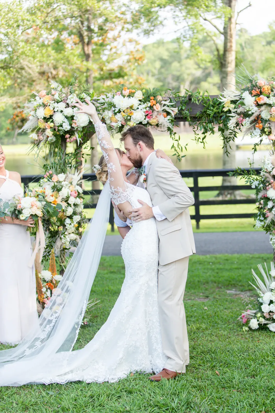 First kiss under stunning floral arch